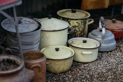 Collection of old rusty pots at street flea market.