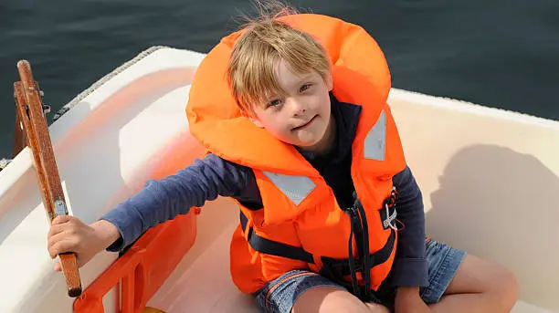 Eight year old boy with down syndrome sailing for the first time alone.http://www.istockphoto.com/file_thumbview_approve.php?size=1&id=17947512