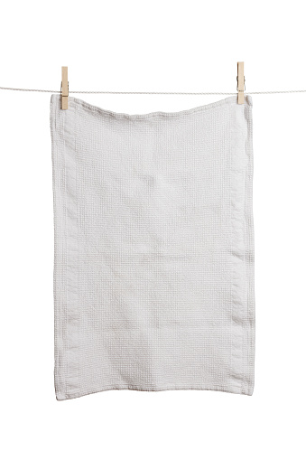 Dishtowel on clothesline. Isolated on white