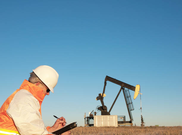 istock Oil Worker in Safety Gear at Well Pumpjack 183859556