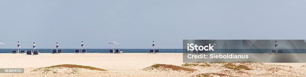Beach chairs and umbrellas in front of blue Atlantic Ocean/Panoramic. Beach chairs and umbrellas in front of blue Atlantic Ocean (panoramic image).related: Beach Stock Photo