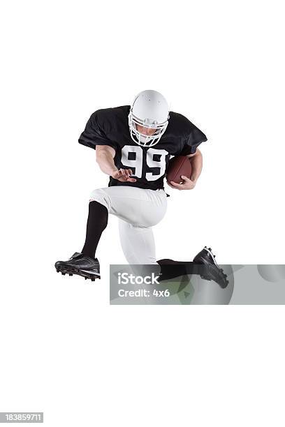 Athletic Football Player Jumping Through The Air Stock Photo - Download Image Now - Hurdling - Track Event, White Background, 20-29 Years