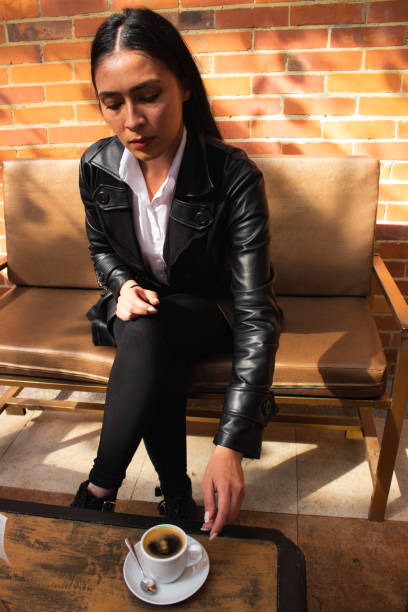 Young woman drinking coffee in a coffee shop