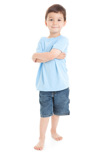 Child on vacation wearing green t-shirt hat over isolated white background happy face smiling looking at the camera. Positive person