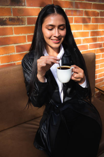 istock Young woman drinking coffee in a coffee shop 1838604388