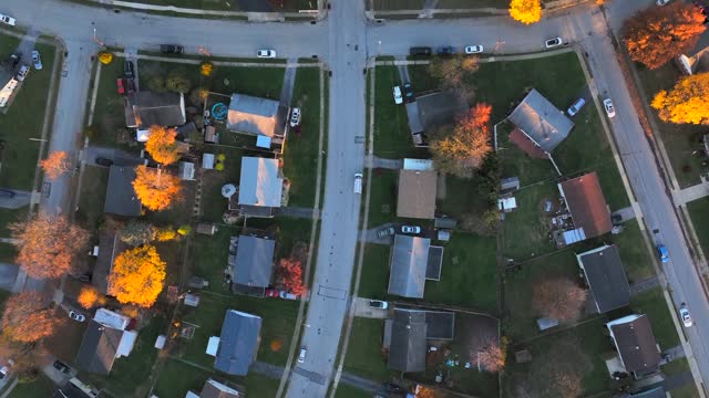 Top down view of American neighborhood during autumn. Quaint houses highlighted by yellow tree foliage in fall.