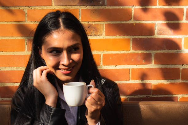 istock Young woman drinking coffee in a coffee shop 1838607158