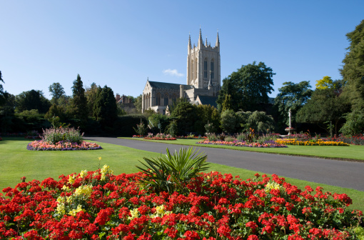 Bury St Edmunds Cathedral seen from Abbey Gardens full of colourful flower beds