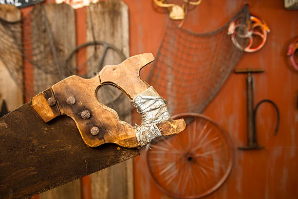 Rusty bow saw blades lying on a wooden table