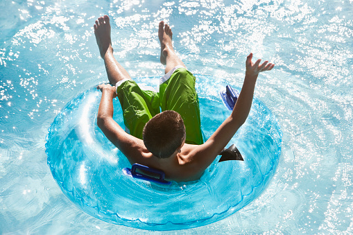 Boy, 13 years, at water park, sliding down water slide