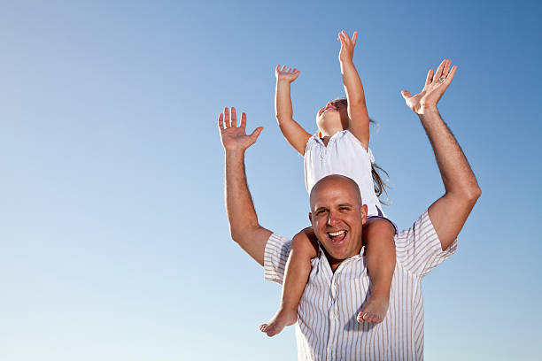 istock Father with little girl on shoulders 183862064