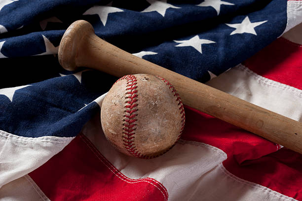 istock baseball and bat on American Flag 183862609