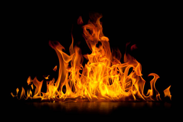 red hot flames of fire isolated on black - yanmış stok fotoğraflar ve resimler