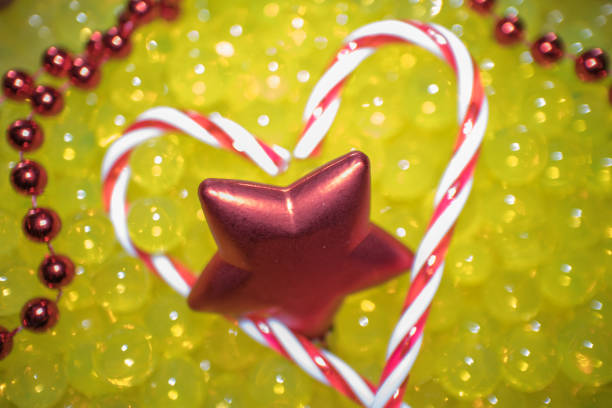 Christmas love, candy canes in heart shape. Holiday greetings with copy space.