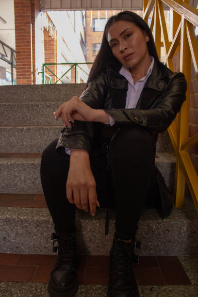 istock Young woman posing and sitting in stairs 1838641270