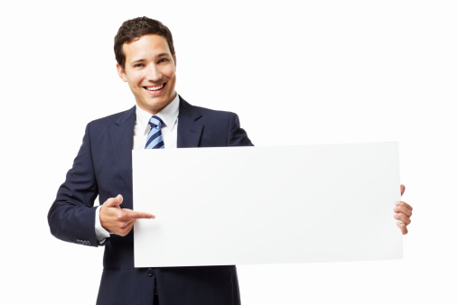 Handsome young businessman points to a blank sign with room for adding text. Horizontal shot. Isolated on white.