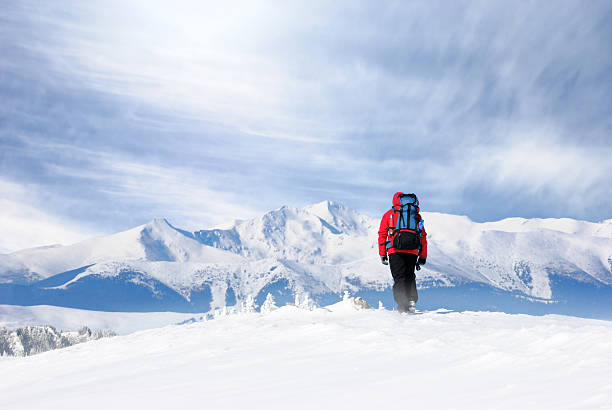 Male adult on the mountain  with beautiful mountain range in front of him