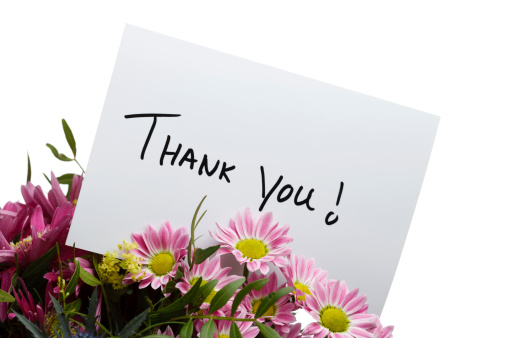 Flower Arrangement with Thank You Note. Isolated on white