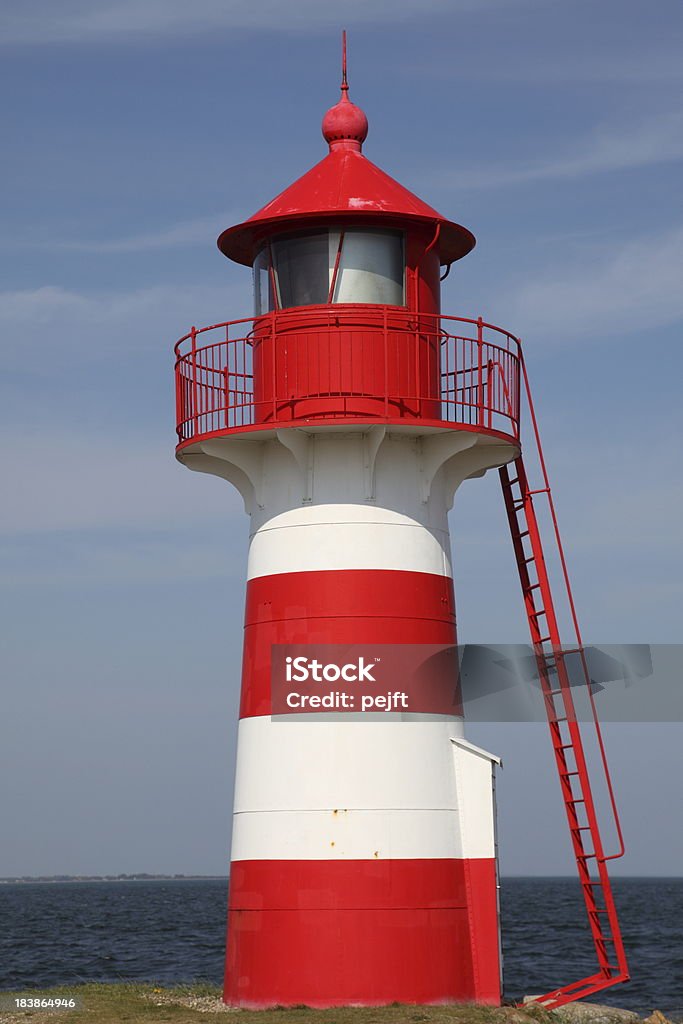 Lighthouse in red and white at Grisetaa Odde "Lighthouse Grisetaa Odde by Limfjorden in the north of Jutland, DenmarkSprog" Bay of Water Stock Photo