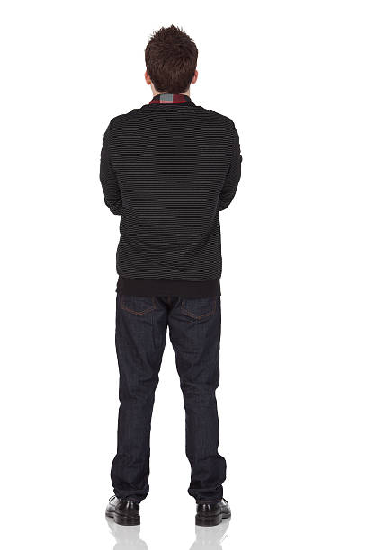 istock Rear view of a man standing with arms crossed 183865250