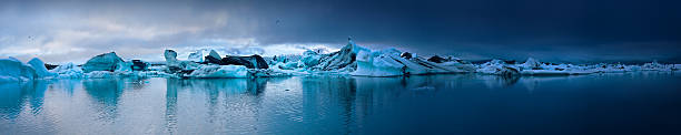 Panoramic view of Jokulsarlon Lagoon Jokulsarlon Lagoon, Skaftafell National Park iceberg dramatic sky wintry landscape mountain stock pictures, royalty-free photos & images