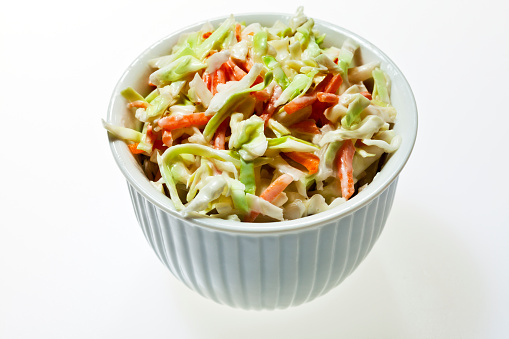 Small ceramic bowl filled with coleslaw.