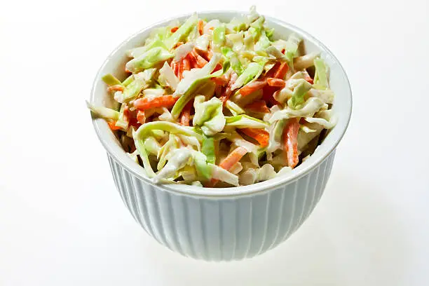 Small ceramic bowl filled with coleslaw.