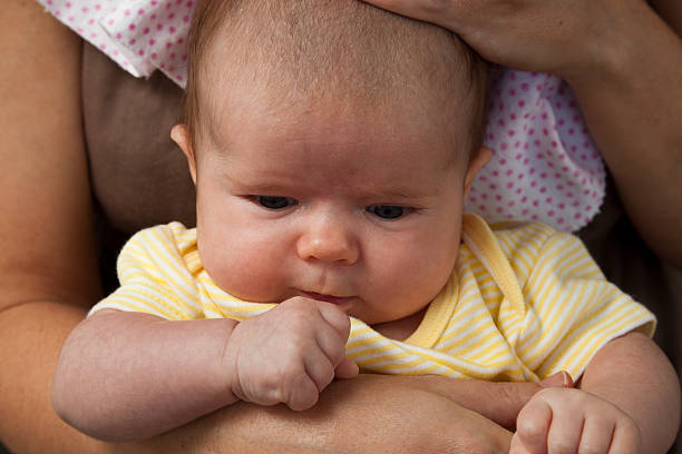 istock Baby Girl Examining Her Hand 183866487