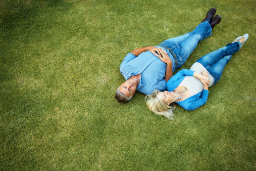 High angle view of a couple relaxing together in the grass