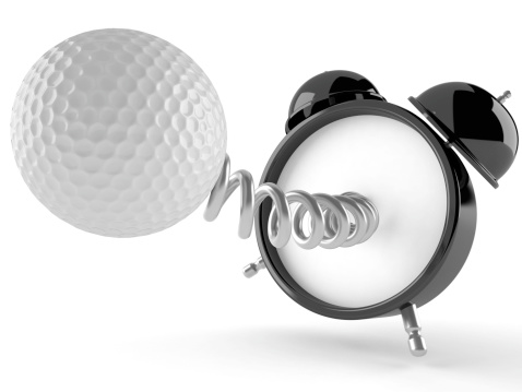 Alarm clock with golf ball isolated on white background