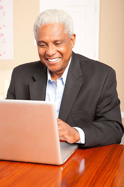 Ethnic man on computer stock photo