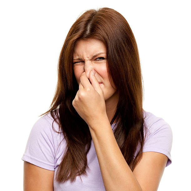 istock Disgusted Young Woman Pinching Nose 183868355