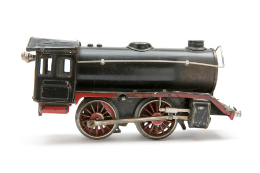 Scale model of an old steam engine. Isolated on a white background.