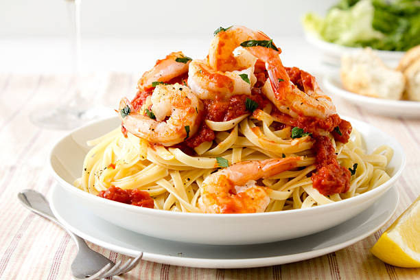 Pasta with king prawns Fresh linguine with king prawns and a tomato and herb sauce.More great images in my food and drink lightbox... prawn seafood photos stock pictures, royalty-free photos & images