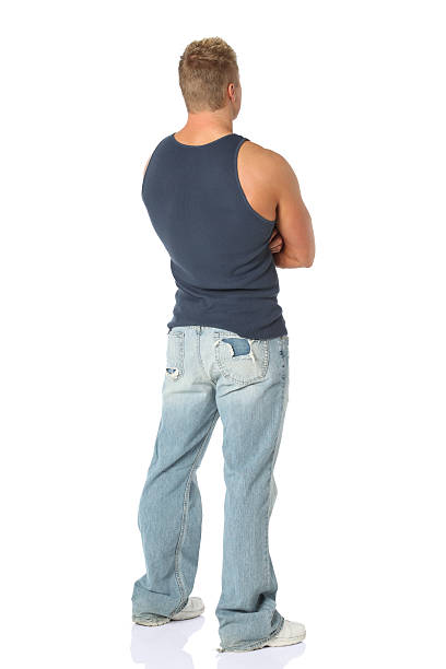 istock Rear view of a man standing with arms crossed 183870033