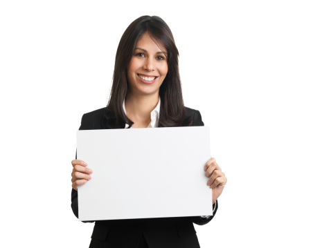 Beautiful businesswoman holding a blank sign and smiling at the camera