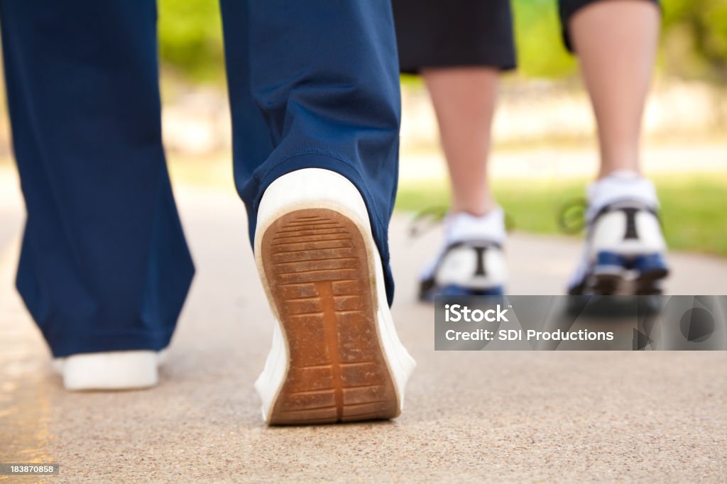 Closeup of Walker's Shoes on a Pathway Closeup of Walker's Shoes on a Pathway. Active Lifestyle Stock Photo