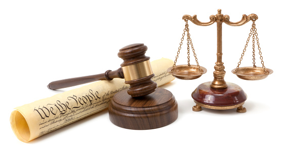 Gavel, the Constitution and scales of justice.