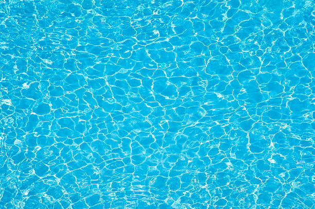 Pool water Textured water wave. Sun reflections in pool water from above. shallow stock pictures, royalty-free photos & images