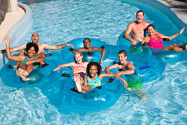 istock Family groups on inner tubes at water park 183872450