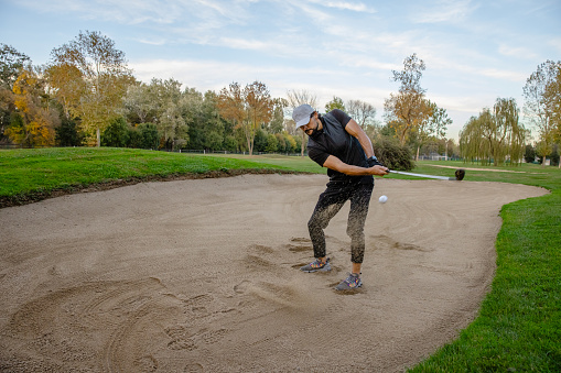 Golfers hit the ball in the sand. Speed and Strength