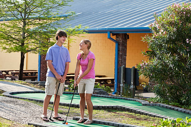 istock Teenage couple playing miniature golf 183873330