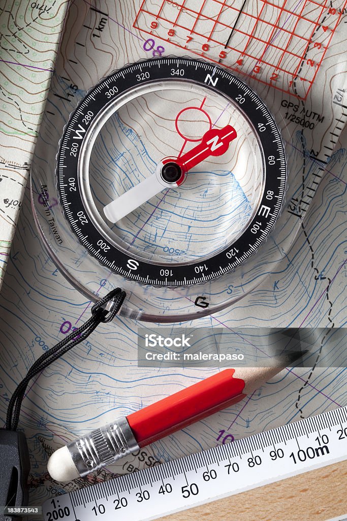 Compass on topographic maps. Adventure Stock Photo