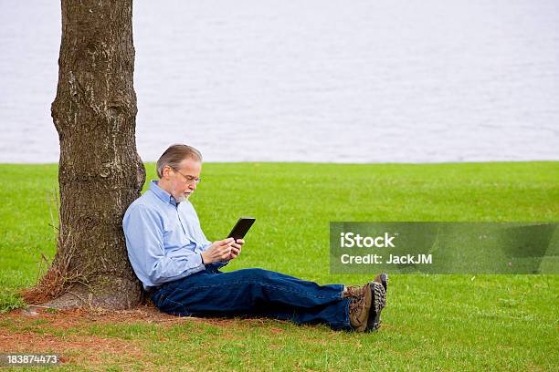 Relaxing With An Ebook Stock Photo - Download Image Now - Adult, Book, Communication