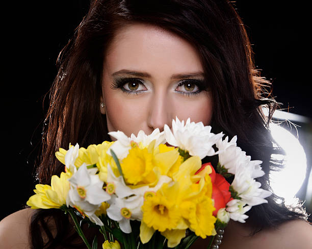 istock girl smelling flowers 183874972