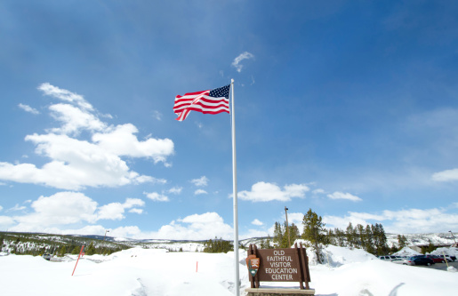 Old Faithful Visitor Centre - Yellowstone National Park.   American Flag.