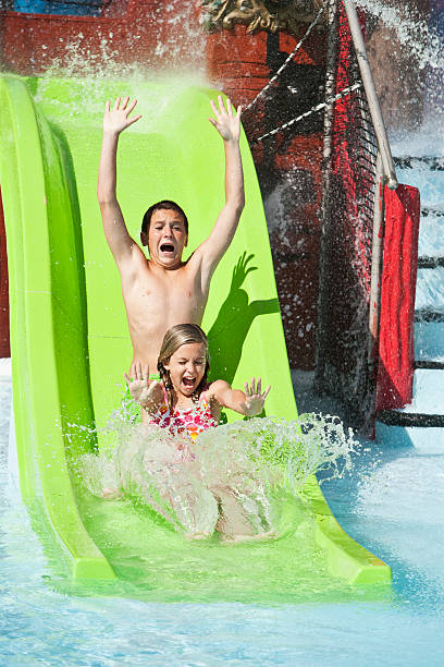 istock Children screaming down slide at water park 183875852