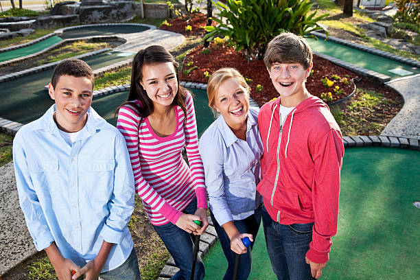 istock Teenagers playing miniature golf 183876023