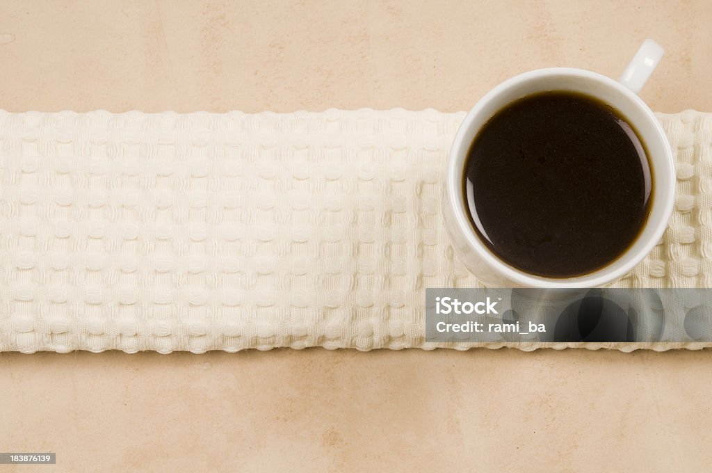 Cup of coffee on a kitchen towel White Cup of Dark coffee on a white / beige kitchen towel Backdrop - Artificial Scene Stock Photo