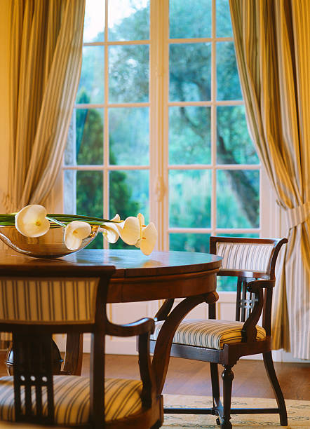 istock Classical house, round wooden table and chairs, window with curtains 183876405
